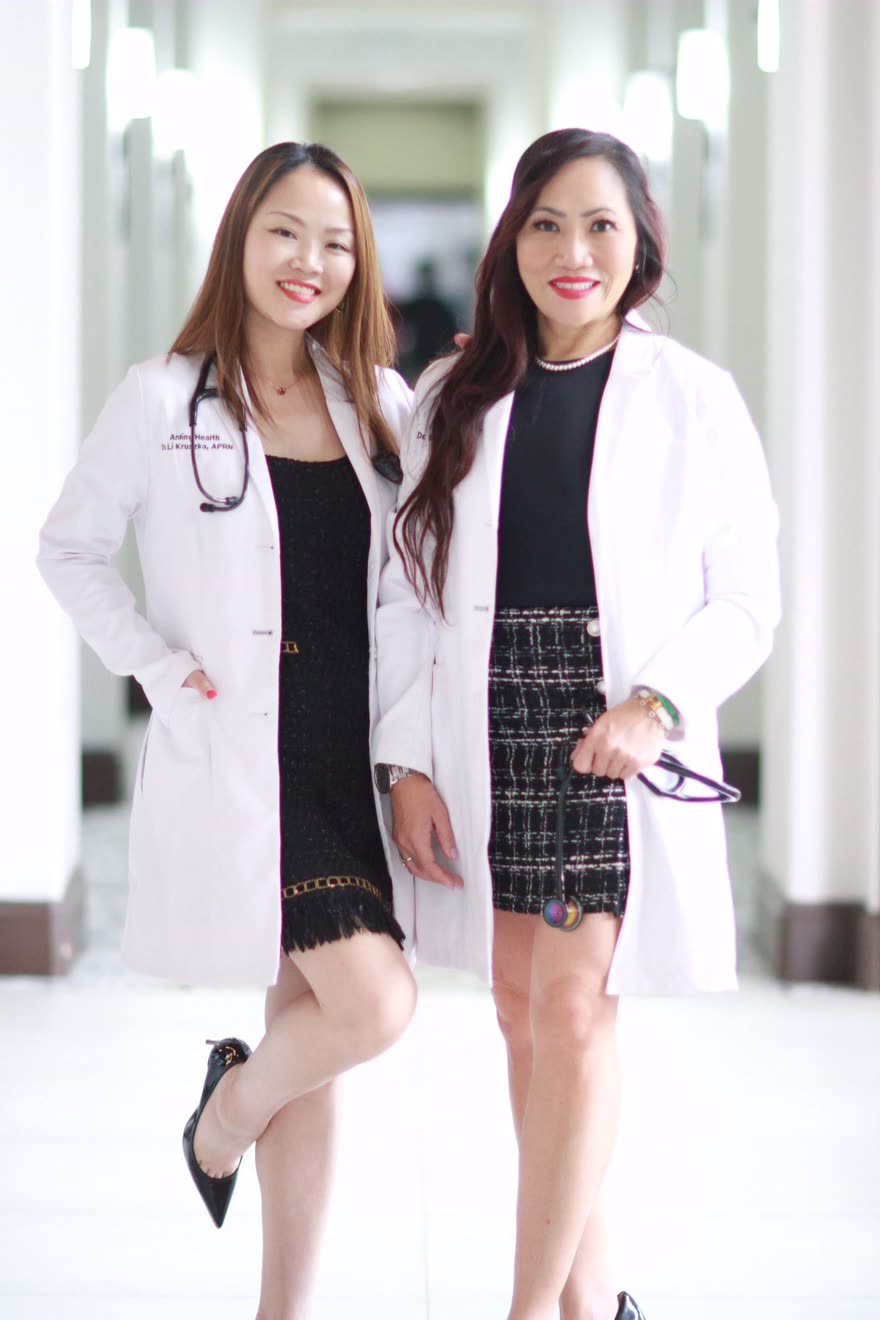 Dr. Li Kruszka and Dr. Winnie Wong, founders of Anling Health, standing together in white coats.